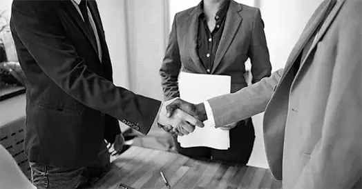 B&W image with 2 people shaking hands